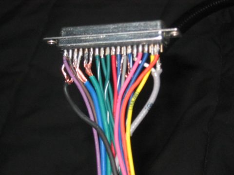 1991 Ford Bronco - A close-up view shows a silver electrical connector with numerous wires of various colors attached.