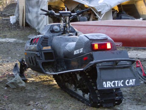 1982 Chevrolet C/K Pickup - Rear view of an Arctic Cat snowmobile with visible branding on the side and rear.