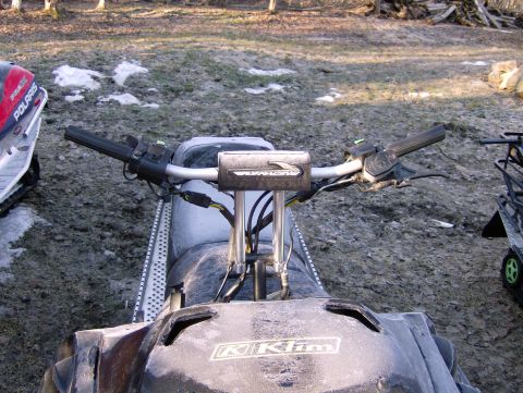 1982 Chevrolet C/K Pickup - The handlebars and front section of a snowmobile are visible, with another snowmobile parked nearby.