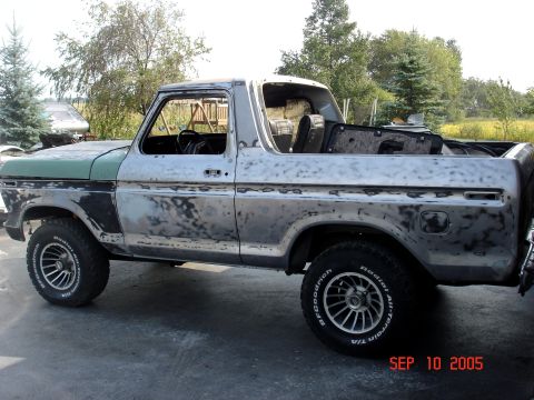 1979 Ford Bronco - This 1978 Ford Bronco is undergoing restoration, with its body stripped to bare metal and primer visible.