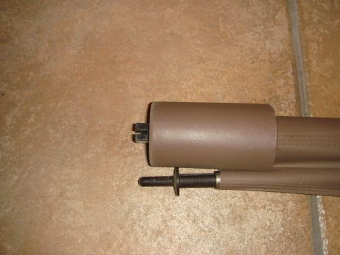 1996 Ford Bronco - Close-up of a tan plastic cargo cover roller assembly with mounting hardware.