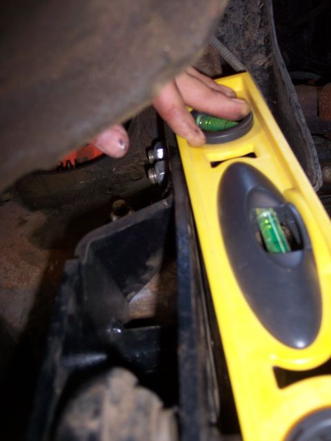 1996 Ford Bronco - Using a level to ensure proper alignment of a vehicle component during installation or repair.