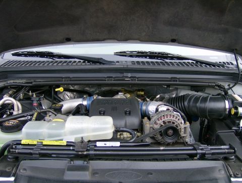 2000 Ford F-250 - The engine bay of a 2000 Ford F-250 shows its diesel powerstroke engine components.