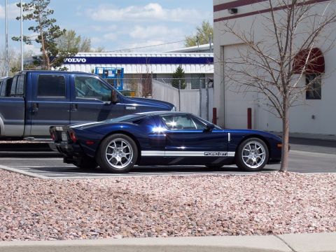 1972 Ford Ranchero - A blue Ford GT sports car is parked next to a blue pickup truck in a parking lot.