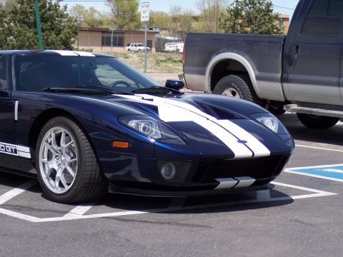 1972 Ford Ranchero - A blue Ford GT sports car is parked next to a pickup truck in a parking lot.