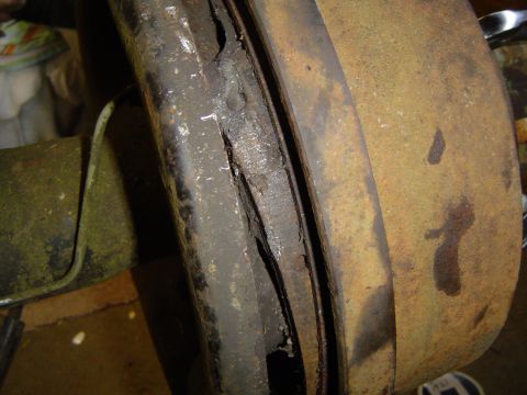 1978 Ford Bronco - Worn brake drum and shoe showing significant damage and rust.