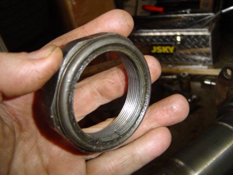 1978 Ford Bronco - Close-up of a Dana 70 FF axle nut being held, showing internal threading.