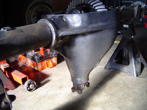 1978 Ford Bronco - Differential housing and axle assembly shown on jack stands, with a tool case visible underneath.
