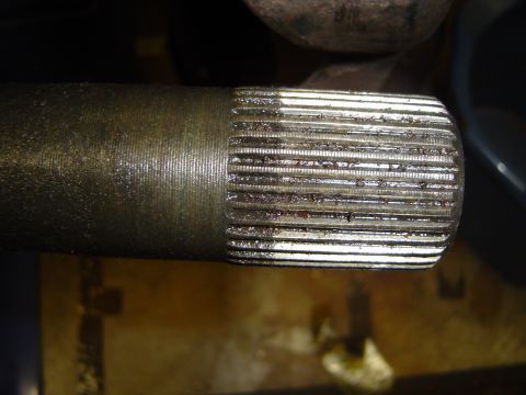 1978 Ford Bronco - The end of a metal shaft shows numerous splines, indicating it's a component for mechanical connection.
