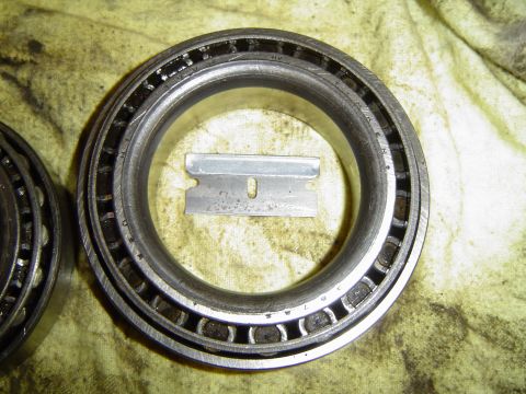 1978 Ford Bronco - A tapered roller bearing is shown with a razor blade placed inside its race.
