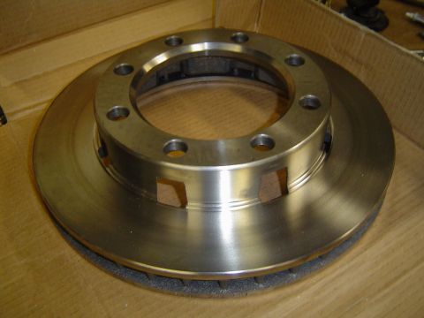 1978 Ford Bronco - A close-up view of a single brake rotor, likely for a heavy-duty vehicle, resting on a cardboard surface.