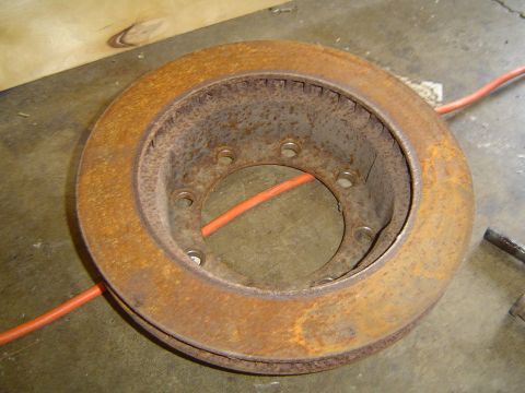 1978 Ford Bronco - A heavily rusted brake rotor with eight lug holes is shown, likely for a truck or heavy-duty vehicle.