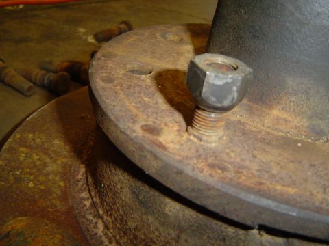 1978 Ford Bronco - Rusty wheel hub assembly with a bolt and nut, possibly for an older vehicle.