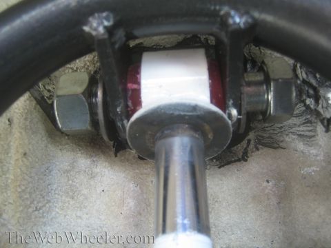 1987 Suzuki Samurai - Detail of a vehicle's suspension system, showing a shock absorber mount with bushings and hardware.