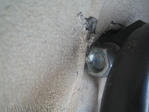 1987 Suzuki Samurai - A close-up view shows a bolt and mounting hardware, likely part of a vehicle's suspension system.