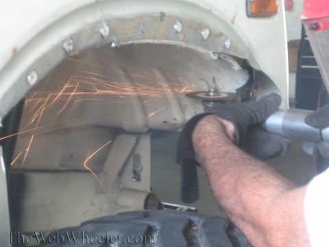 1987 Suzuki Samurai - Grinding sparks fly as a wheel well is modified.