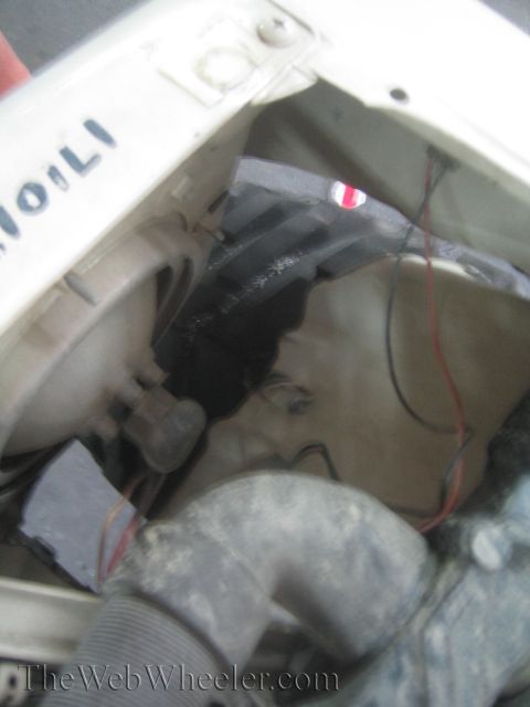 1987 Suzuki Samurai - Close-up view of a vehicle's engine bay, revealing hoses, wires, and some signs of wear and tear.