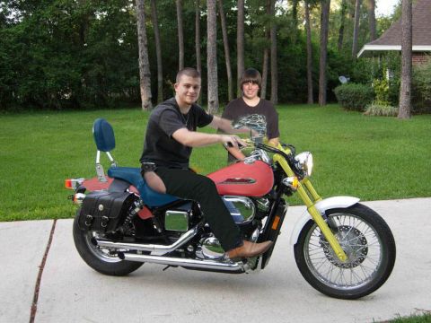 1989 Ford Bronco - Two young men pose with a red motorcycle in a suburban yard.