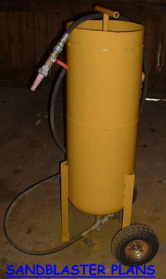1965 Ford Mustang - This sandblaster is yellow and has a hose and nozzle attached. It is on wheels.