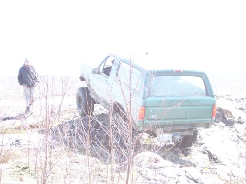 1996 Ford Bronco - 1996 Ford Bronco navigating rough terrain on a bright, overcast day.