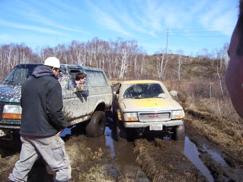 1996 Ford Bronco - Two off-road vehicles are stuck in the mud during an outing.
