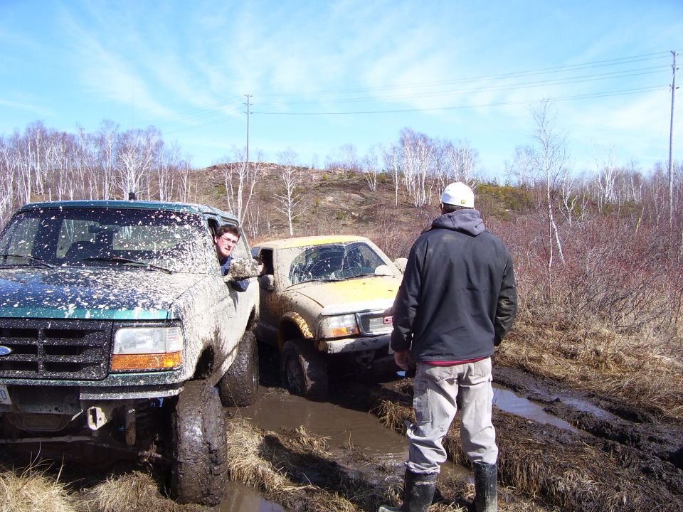 1996 Ford Bronco stuck in mud, 3/4 front view