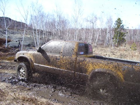 1996 Ford Bronco - Pickup truck stuck in mud during an off-road adventure.