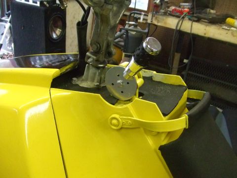 1995 Ford Mustang - Close-up of a custom gear shifter assembly mounted on a yellow console inside a vehicle.
