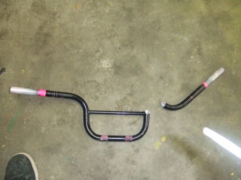 1995 Ford Mustang - Broken motorcycle handlebars are shown on a concrete surface.