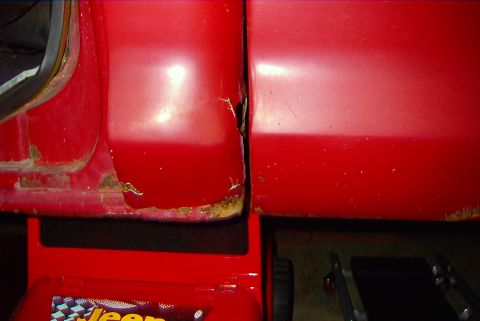 1979 Ford F-150 - Close-up view of the door gap on a red truck, revealing significant rust and wear. The Supermotors.net logo is visible at the bottom right.