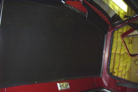 1979 Ford F-150 - The interior of a vehicle is shown, with a focus on the headliner and exposed insulation in the rear.