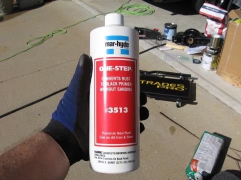 1973 Ford Ranchero - A bottle of Mar-Hyde One-Step rust converter is held in a gloved hand, with various tools and supplies in the background.
