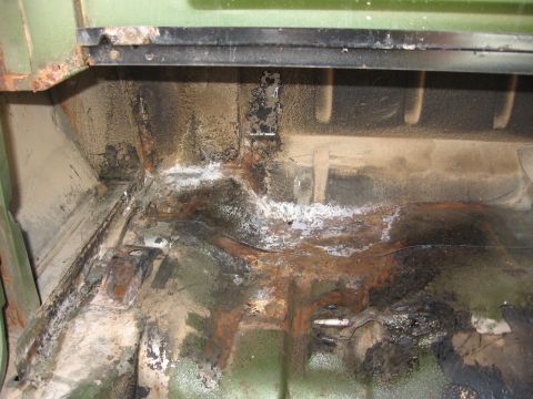 1973 Ford Ranchero - The floor pan shows significant rust and corrosion, with white powdery residue and dark staining.
