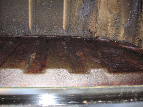 1973 Ford Ranchero - Corroded floor pan showing signs of water damage and rust accumulation.