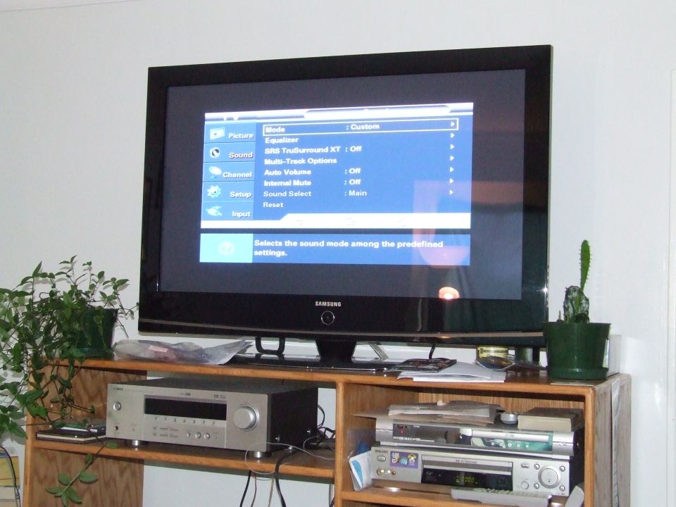 Samsung TV showing sound settings menu. Stereo receiver and VCR below