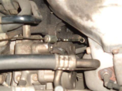 1989 Mazda MX-6 - A detailed view of various engine parts and hoses within a vehicle.