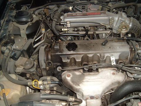 1989 Mazda MX-6 - Close-up view of the engine compartment, highlighting the 2.2L turbo engine components and their arrangement.