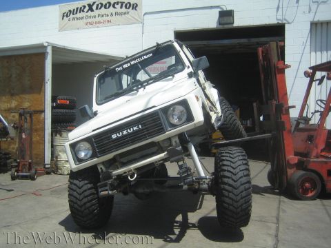 1987 Suzuki Samurai - Suzuki Samurai is lifted by a forklift at FourXDoctor, a 4 Wheel Drive Parts & Repair shop.