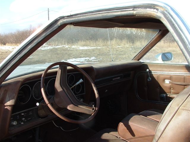 1975 Ford Ranchero interior, brown upholstery, dashboard, steering wheel, door panel, and Supermotors.net watermark