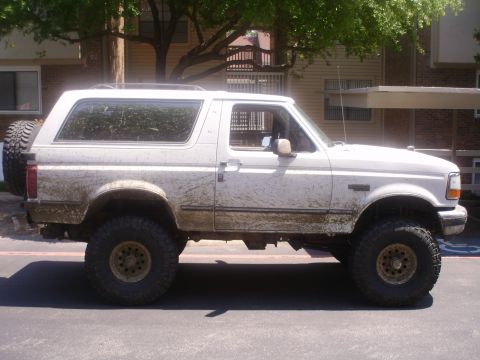 1992 Ford Bronco - This 1992 Ford Bronco is shown from the side, heavily splattered with mud.