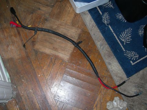 1992 Ford Taurus - Battery cables are shown laid out on a wooden floor.