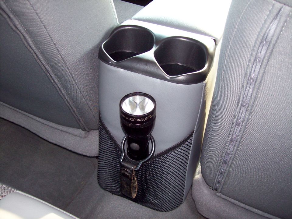 Gray rear center console cup holders with Mag-Lite flashlight in mesh pocket