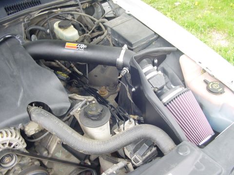 2002 Ford Crown Victoria - Close-up view of a K&N air intake system installed in a vehicle's engine bay.