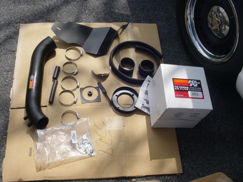 2002 Ford Crown Victoria - A K&N air intake system is laid out on cardboard, ready for installation.