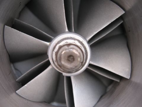 1996 Ford Probe - This is a close-up view of a turbocharger's compressor wheel, showing its angled blades and central hub.