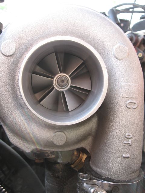 1996 Ford Probe - Close-up view of a turbocharger, showing its internal fins and external stamped markings.