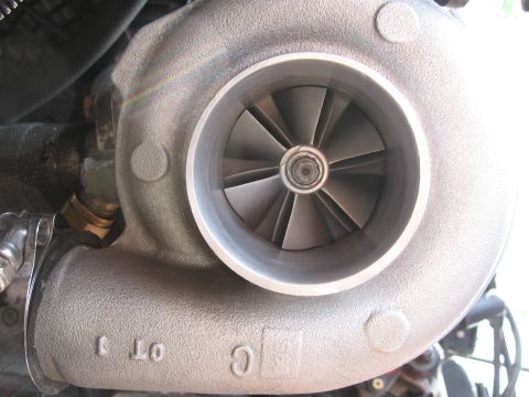 1996 Ford Probe - Close-up view of a turbocharger, showing its internal impeller and external casting details.