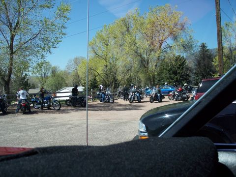 1972 Ford Ranchero - A group of motorcycles and riders are gathered in a parking lot on a sunny day.