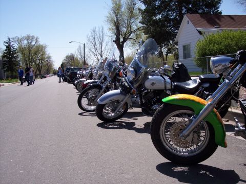 1972 Ford Ranchero - A line of motorcycles are parked on the side of a street on a sunny day.