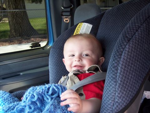 1972 Ford Ranchero - A smiling baby is secured in a car seat, ready for a drive.